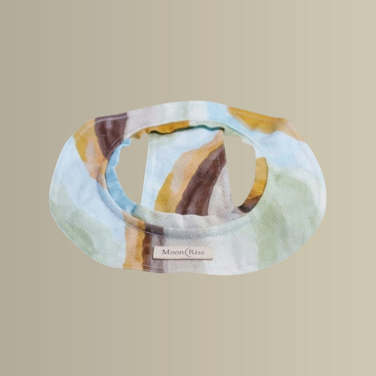 Colorful bucket hat with 'Moon Rise' label on a beige background
